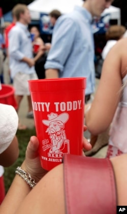 FILE - Health officials say open containers of food, shared cups of refreshment and lack of immediate hand sanitizing dispensers make tailgate gatherings, like this one at the University of Mississippi in Oxford, opportunities for students and fans to be exposed to viruses.