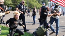 Police officers break up a fight between supporters of U.S. President Donald Trump and Black Lives Matter protesters outside the Oregon State Capitol building in Salem, Oregon, U.S. September 7, 2020.