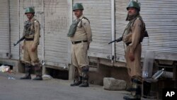 Indian paramilitary soldier stand guard on a deserted street during curfew in Srinagar, Indian-controlled Kashmir, July 12, 2016. Three days of violence have wracked the disputed Himalayan region.