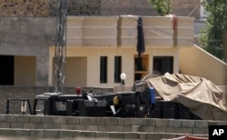 Vehicles are parked inside the compound of a house where it is believed bin Laden lived in Abbottabad, Pakistan.