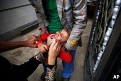 A boy receives a polio vaccination during a polio immunization campaign in Sana'a, Yemen, Aug. 15, 2015.