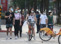 People wear face masks to protect against the spread of the coronavirus after the COVID-19 alert raise to level 3 in Taipei, Taiwan, Saturday, May 15, 2021.