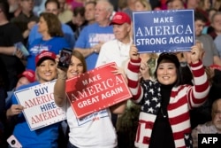 FILE - Supporters take selfies as President Donald Trump arrives at a "Make America Great Again" rally in Louisville, Ky., March 20, 2017.
