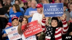 FILE - Supporters take selfies as President Donald Trump arrives at a 'Make America Great Again' rally in Louisville, Kentucky, March 20, 2017.