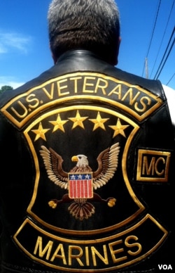 Marine Corps Brian Prochaska of the US Veterans Motorcycles Club displays the patches of his club. (A. Phillips/VOA)
