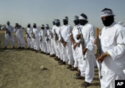 FILE - Taliban suicide bombers stand guard in the border area of Zabul province, Afghanistan, Aug. 15, 2016.