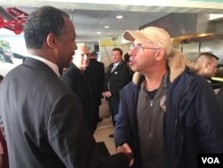 Presidential candidate Dr. Ben Carson shakes the hand of a local resident at the Airport Diner in Manchester, New Hampshire, Feb 7, 2016. (K. Gypson/VOA)