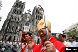FILE - Catholic Archbishop of Hanoi Peter Nguyen Van Nhon waves to believers in front of St. Joseph Cathedral after Sunday mass in Hanoi, May 23, 2010.