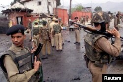 FILE - Indian Border Security Force troopers stand guard near the scene of a car bomb explosion outside the Jammu and Kashmir State Legislative Assembly Complex in the heart of Srinagar, Oct. 1, 2001.