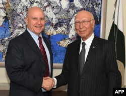 In this handout photograph released by the Press Information Department (PID) on April 17, 2017, Pakistan's National Security Advisor Sartaj Aziz (R) shakes hands with US National Security Advisor Lieutenant-General H.R. McMaster at the Foreign Ministry in Islamabad.