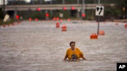 A woman walks along flooded President Street after Hurricane Matthew slammed Savannah, Georgia, Oct. 8, 2016.
