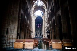 A view of the damaged roof and debris inside Notre-Dame de Paris in the aftermath of a fire that devastated the cathedral during the visit of French Interior Minister Christophe Castaner (not pictured) in Paris, France, April 16, 2019.