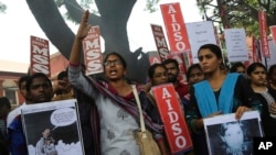 A member of a students organization shouts slogans as others carry placards asking justice for Asifa, an 8-year-old Muslim girl who was raped and murdered, during a protest in Bangalore, India, Friday, April 13, 2018.