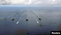 FILE - The USS Nimitz, USS Kitty Hawk and USS John C. Stennis Carrier Strike Groups transit in formation during Valiant Shield 2007 in the Pacific Ocean in this Aug. 14, 2007 photo.