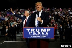 Republican U.S. presidential nominee Donald Trump (R) and vice presidential candidate Mike Pence (L) hold a campaign rally in Cleveland, Oct. 22, 2016.