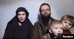 FILE - A still image from a video posted by the Taliban on social media on Dec. 19, 2016, shows American Caitlan Coleman speaking next to her Canadian husband, Joshua Boyle, and their two sons.