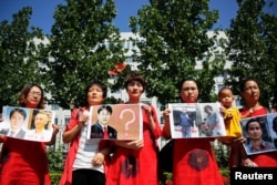 FILE - Relatives of those detained in what is known as the "709" crackdown protest in front of the Supreme People's Procuratorate in Beijing, China, July 7, 2017.On July 9, 2015, the authorities launched what rights groups say was a coordinated attempt to quash China's rights movement, rounding up hundreds of rights lawyers and activists, in what is known as the "709" crackdown.