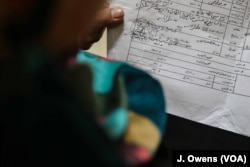 Reja holds the paperwork that proves she has legitimately registered the marriage. She had to register the marriage in order to get a divorce that allowed her to claim child support.