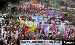 Activists display banners and placards as they march near the House of Representatives to protest President Rodrigo Duterte's State of the Nation address in Quezon city, Metro Manila, in Philippines, July 23, 2018.