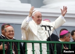 FILE - Pope Francis gestures while addressing the crowd from the Cathedral of Our Lady of the Assumption in Santiago, Cuba, Sept. 22, 2015.