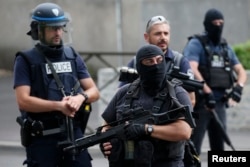 French police and anti-crime brigade (BAC) members secure a street as they carried out a counter-terrorism swoop at different locations in Argenteuil, a suburb north of Paris, France, July 21, 2016.