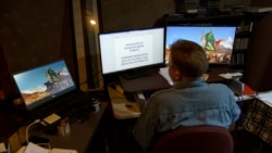Caroline Clarin works in her basement on applications to get the Afghans who worked for her program out of the country, in Dalton, Minn., Oct. 26, 2021.