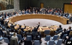 FILE - In this photo provided by the United Nations, members of the United Nations Security council vote at the United Nations headquarters on Friday, Dec. 23, 2016, in favor of condemning Israel for its practice of establishing settlements in the West Bank.