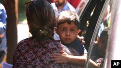 A child from Honduras is brought to the United States Immigration and Customs Enforcement office in Grand Rapids, Mich., July 10, 2018.