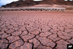 FILE - What was once a marina sits high and dry because of the receding water in the Lake Mead National Recreation Area in Arizona, July 16, 2014.
