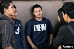 FILE - Eddie Alberto, center, waits in line for assistance with paperwork for the Deferred Action for Childhood Arrivals program at the Coalition for Humane Immigrant Rights of Los Angeles in Los Angeles, California, Aug. 15, 2012.