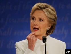 Democratic presidential nominee Hillary Clinton listens to Republican presidential nominee Donald Trump during the third presidential debate at UNLV in Las Vegas, Oct. 19, 2016.