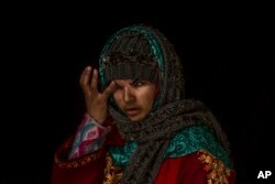 Insha Mushtaq Malik poses for a portrait inside her home in Sedow, south Kashmir, Nov. 29, 2016. Insha says she was standing by the window of her village home watching protesters and troops skirmish when more than a 100 pellets hit her face.