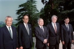 FILE: From left to right : Kieu Samphan, leader of the pro-Chinese Red Khmers, Son Sann, leader of the Nationalist party, Prince Norodom Sihanouk, leader of the Cambodian resistance, Roland Dumas, French Minister of Foreign Affairs, and Hun Sen, Prime Minister of the Phnom Penh government, pose before starting round table talks on July 25, 1989 in La Celle Saint Cloud, France. From July 30 to August 30, 1989, representatives of 18 countries, the four Cambodian parties, and the UN Secretary General met in Paris in an effort to negotiate a comprehensive settlement : withdrawal of the remaining Vietnamese occupation troops and genuine self-determination for the Cambodian people.