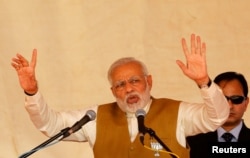 FILE - India's Prime Minister Narendra Modi addresses his supporters during a campaign meeting ahead of Gujarat state assembly election in Kalol on the outskirts of Ahmedabad, India, Dec. 8, 2017.