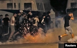 Police disperse revellers at the old port of Marseille after the England v. Russia - Group B match.