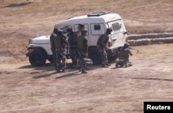 Indian army soldiers take their positions near a security camp during a gunbattle with suspected militants on the outskirts of Srinagar, Indian-controlled Kashmir, Oct. 3, 2017.
