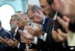 FILE - Turkey's President Recep Tayyip Erdogan, offers his prayers, during a prayer for the victims of the July 15, 2016, failed coup attempt, at the mosque of the Presidential Palace in Ankara, Turkey, July 14, 2017.