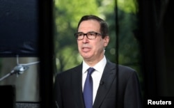U.S. Treasury Secretary Steve Mnuchin speaks during a TV interview at the White House in Washington, U.S., May 21, 2018.