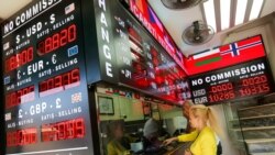 Customers buy and sell money at a currency exchange office in Istanbul, Turkey September 27, 2021.