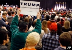 A supporter waves a sign as Republican presidential candidate Donald Trump speaks during a campaign rally in Pittsburgh, April 13, 2016.