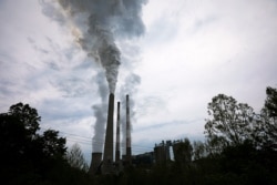 FILE - Exhaust rises from the stacks at a coal-fired electricity-generating power station in Haywood, West Virginia, May 16, 2018.