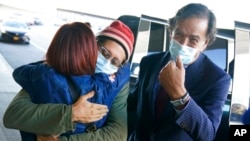 FILE - Danny Fenster, center, hugs his mother Rose Fenster as the late former U.S. diplomat Bill Richardson, right, looks on, at John F. Kennedy Airport in New York, Nov. 16, 2021. Journalist Fenster was held in a Myanmar prison.