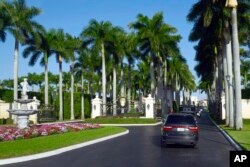 The motorcade with President Donald Trump, drives into the Trump International Golf Club in West Palm Beach, Fla., Nov. 21, 2018.
