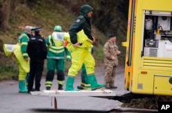 FILE - Military forces work on a van in Winterslow, England, March 12, 2018, as investigations continue into the nerve-agent poisoning of Russian ex-spy Sergei Skripal and his daughter, Yulia, in Salisbury, England, on March 4, 2018.