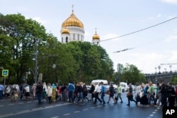 Russian Orthodox believers cross the road to line up to kiss the relics of Saint Nicholas that were brought from an Italian church where they have lain for 930 years, in the Christ the Savior Cathedral in Moscow, Russia. The photo was taken May 26, 2017.