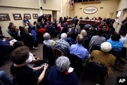 FILE - Ferguson residents pack the council chambers for a meeting of the City Council in Ferguson, Missouri, Feb. 2, 2016.