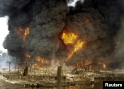 FILE - Nigeria's amnesty program for ex-militants was begun in 2009 to stop the sabotage of oil facilities, like this attack on a pipeline in Andoni in December 2005.