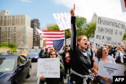 FILE - Demonstrators take part in an anti-Trump "March for Truth" rally at Foley Square on June 3, 2017 in New York City.