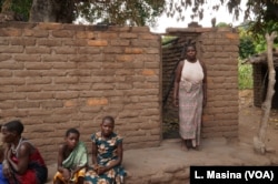 Aidah Waisoni standing outside his burnt house in Phalombe district.
