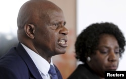 Zimbabwe's Finance Minister Patrick Chinamasa (L) addresses a media conference after meeting International Monetary Fund (IMF) Executive Director for Africa Chileshe Kapwepwe (R) in Harare, September 7, 2015.